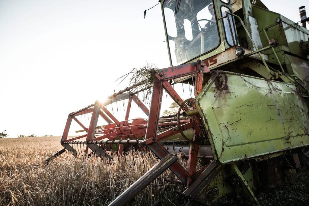 A tractor harvesting Scottish barley that will be used to make Bruichladdich whisky