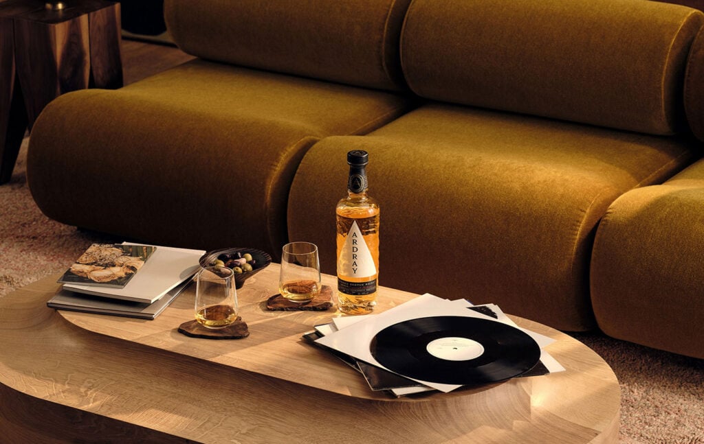 A bottle of Ardray blended Scotch whisky among records and food