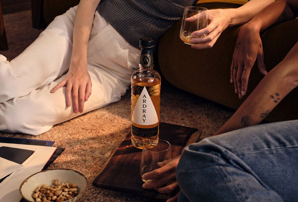 A couple enjoying a bottle of Ardray blended Scotch whisky