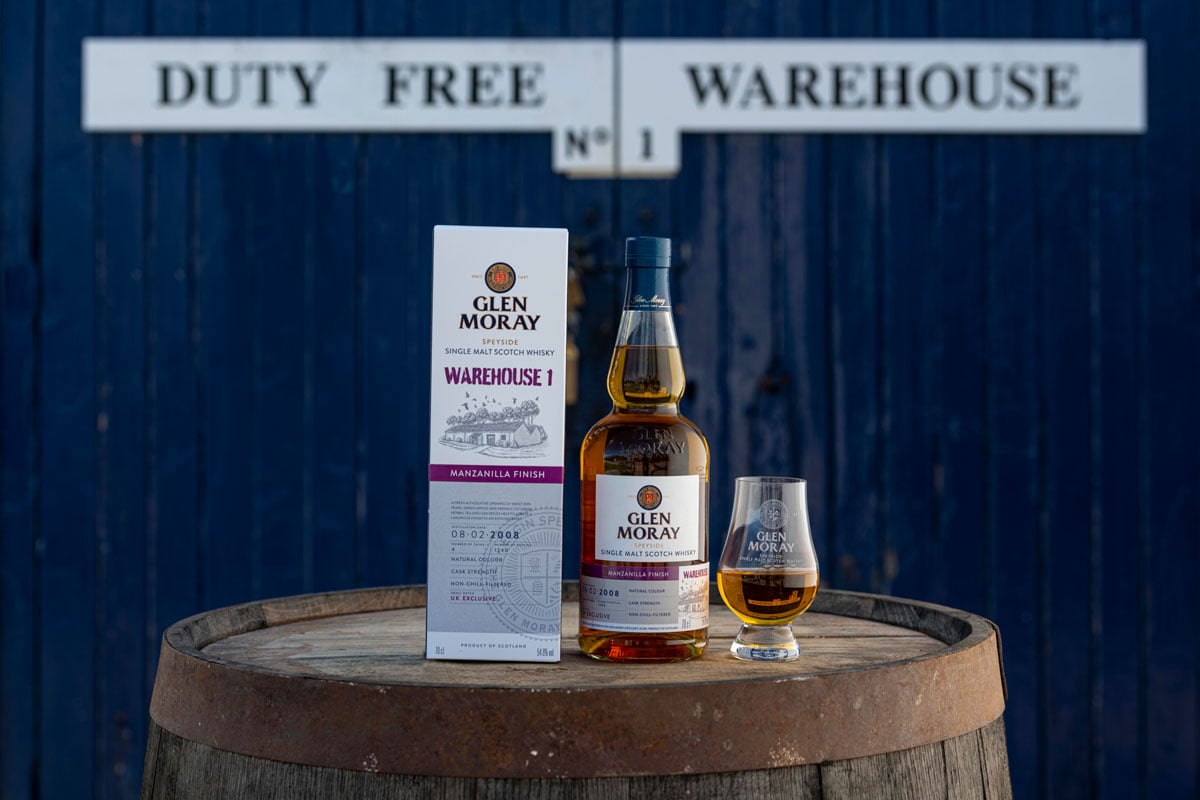 Glen Moray Manzanilla Finish bottle in front of Warehouse 1 doors