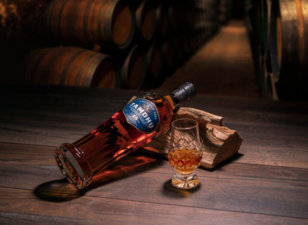 Tamdhu 15 Year Old pictured in a warehouse with a Glencairn glass. It's an example of a premium whisky