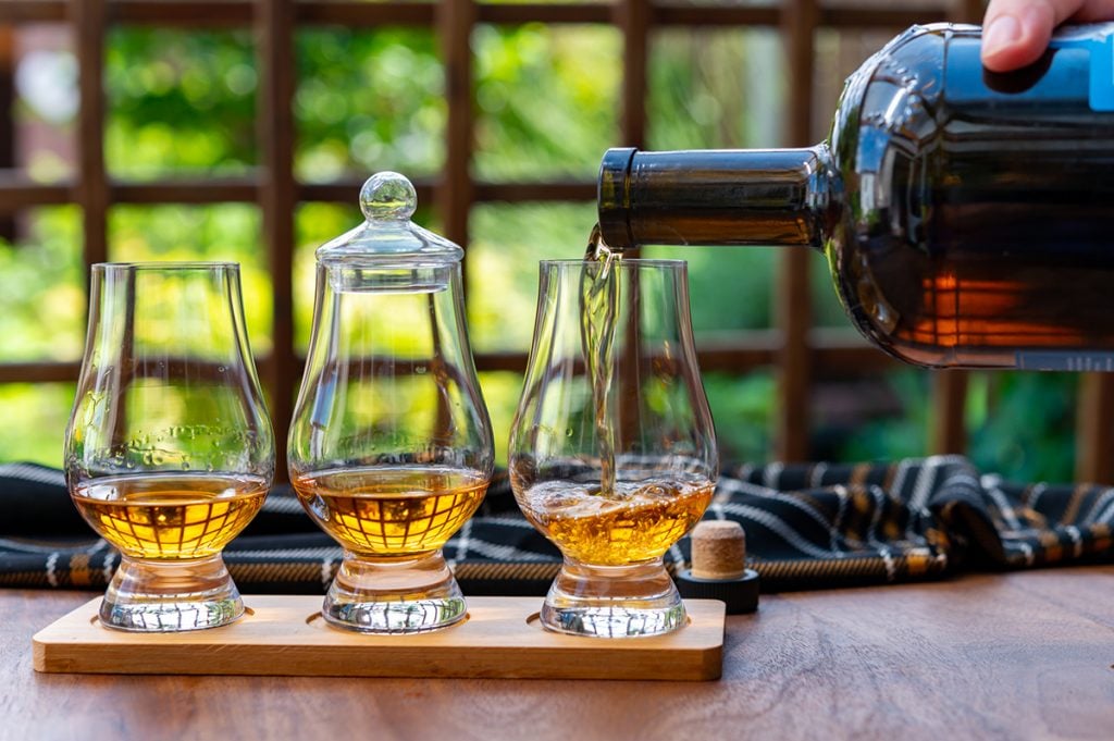 Glasses of Japanese whisky being filled