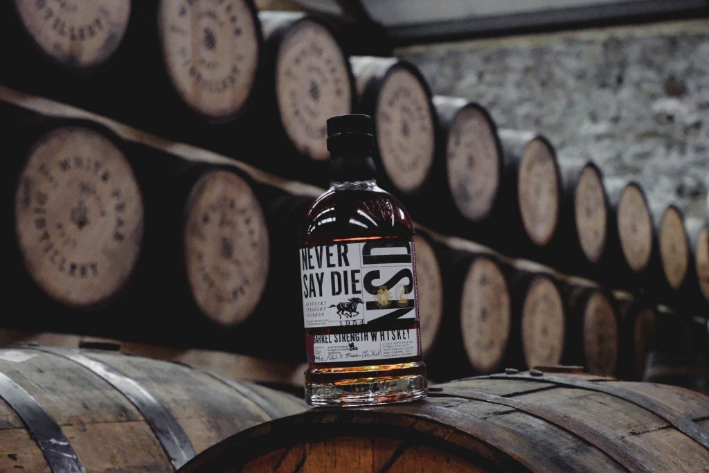 Never Say Die bottle on a barrel