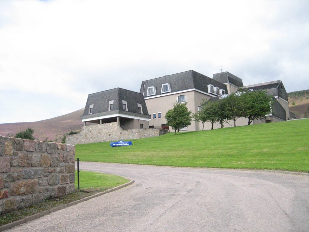 A photo of the Allt-á-Bhainne Distillery capturing the buildings and some of the surrounding area