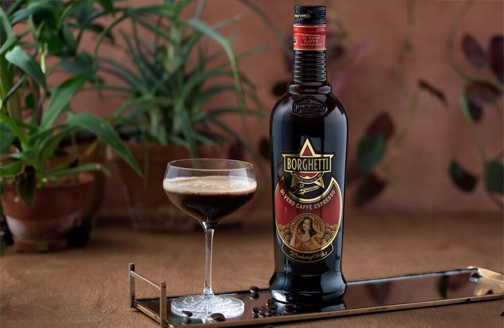 A bottle of Caffè Borghetti Espresso Liqueur and an Espresso Martini