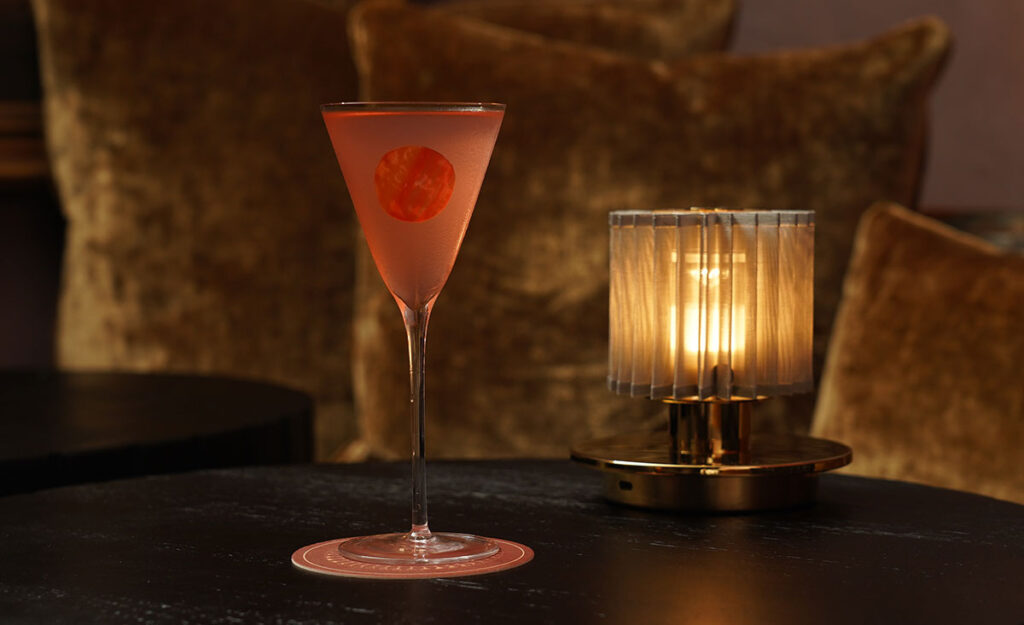 A miniature glass of a cocktail called the Melba Rob Roy at Archive & Myth bar in London