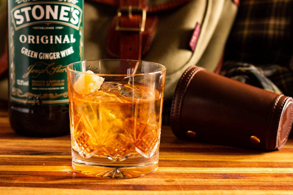 A Whisky Mac Cocktail with a bottle of Stone's Original Green Ginger Wine and a bag