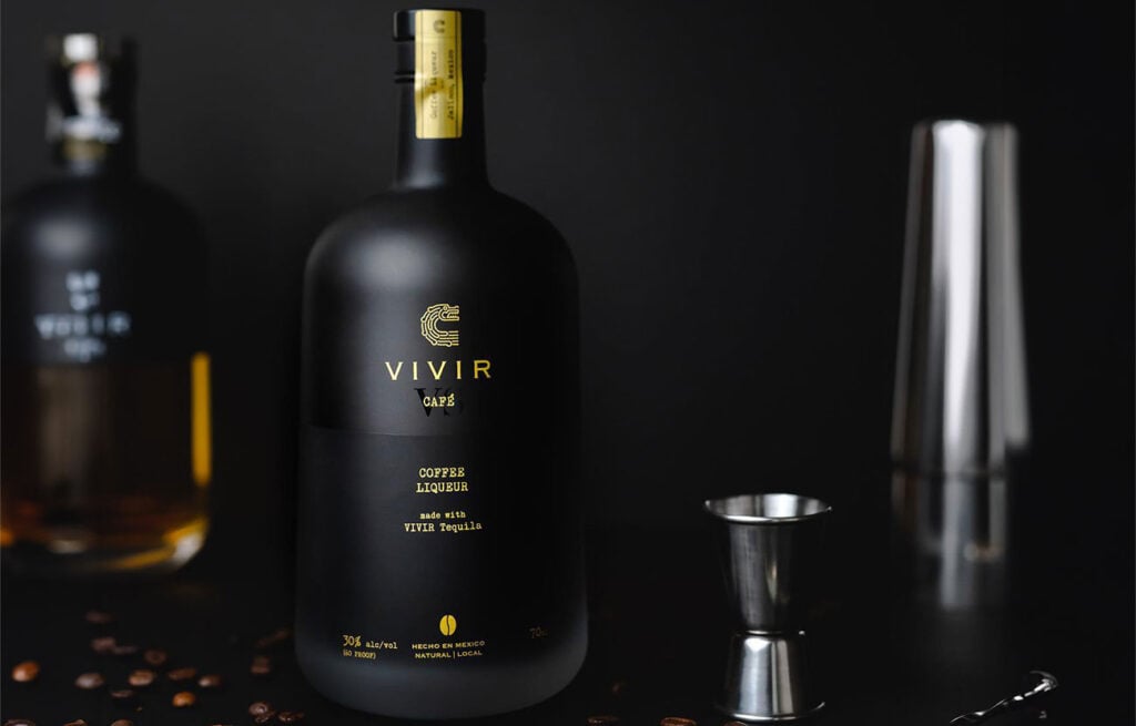 A bottle of VIVIR Café VS Coffee Liqueur and cocktail equipment