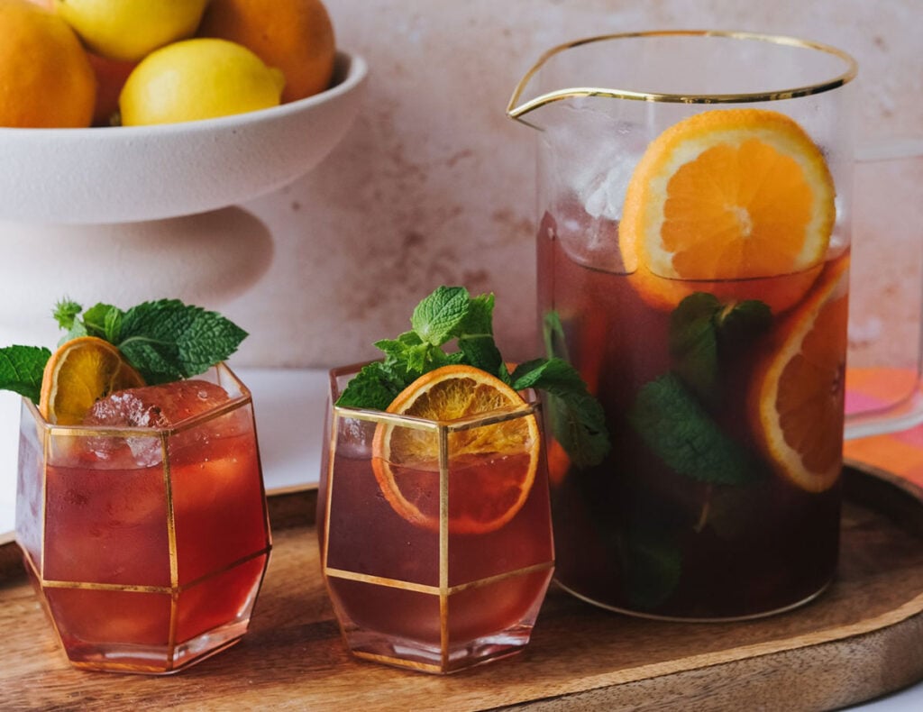 A pitcher and glasses of the Vibey Iced Tea mocktail