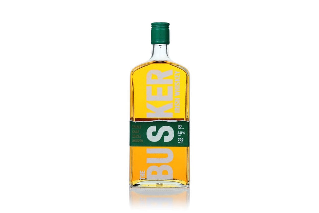 A 70cl bottle of The Busker Triple Cask Triple Smooth Irish Whiskey on a white background, an affordable whisky for budget-conscious drinkers