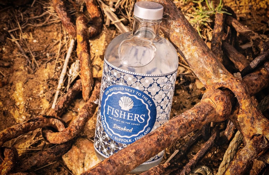 A bottle of Fishers Smoked Gin in the woods