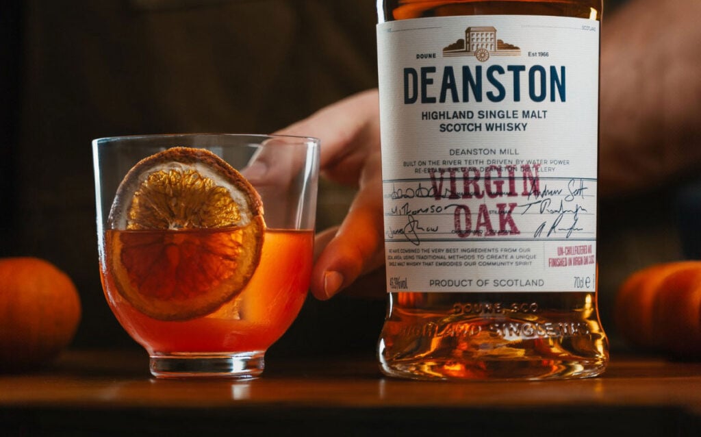 A Spiced Oak Old Fashioned cocktail with Deanston Virgin Oak, both bottle and cocktail are pictured
