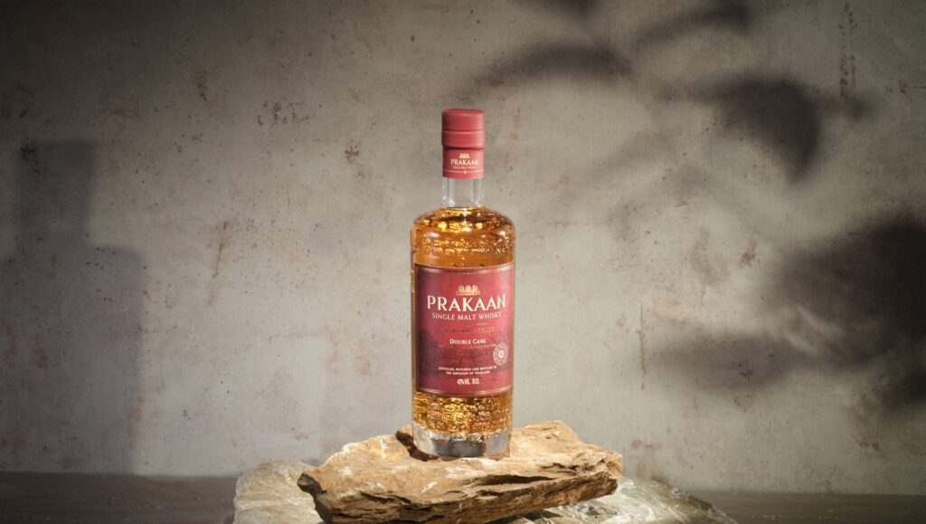 A bottle and glass of Prakaan Double Cask Thai Single Malt Whisky