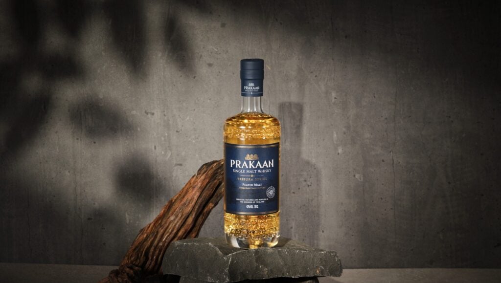 A bottle and glass of Prakaan Peated Malt Thai Single Malt Whisky