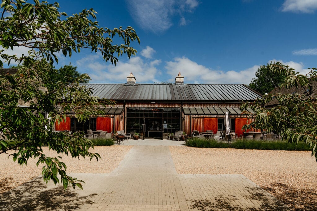 The exterior of The Cotswolds Distillery in the summer