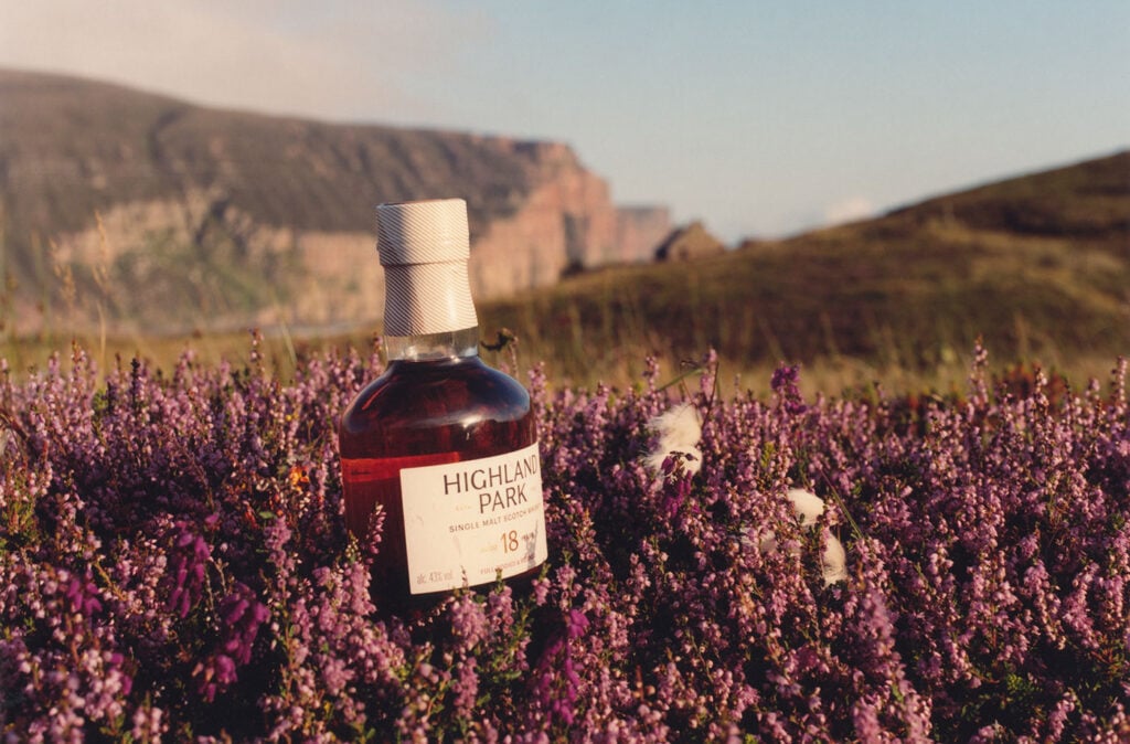 Heather fields on Orkney with a bottle of Highland Park 18 Year Old
