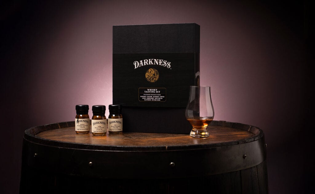 The Darkness Tasting Set on a whisky barrel, one of our top new releases in July