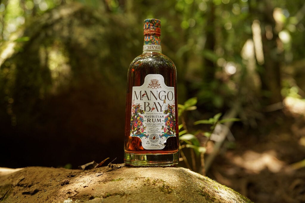 A bottle of Mango Bay Rum in the jungle