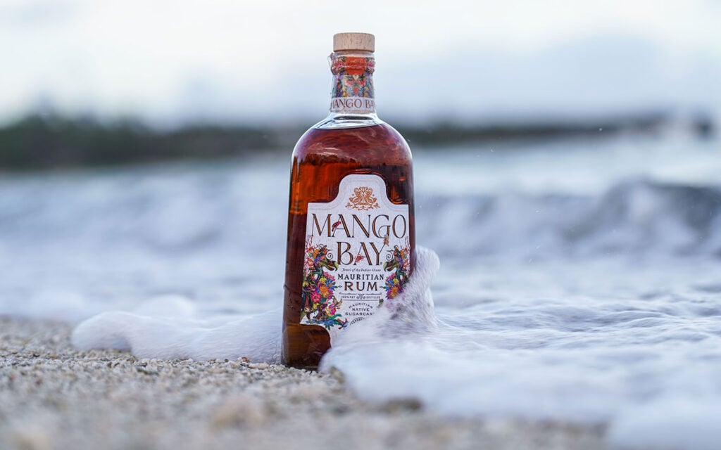 A bottle of Mango Bay Rum in the sea