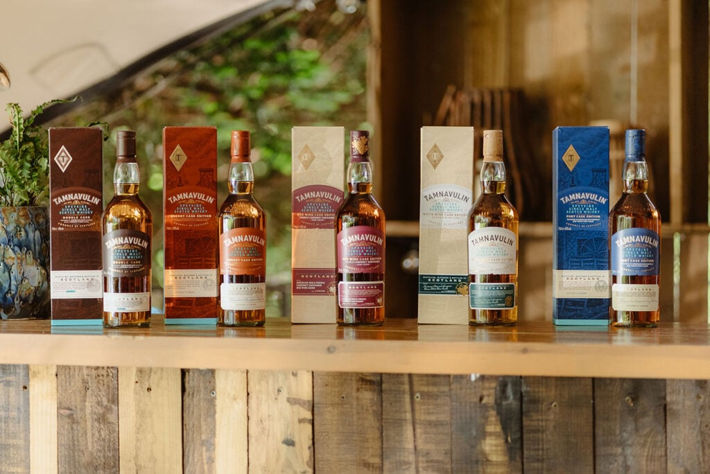 A range of Tamnavulin whiskies on a bar