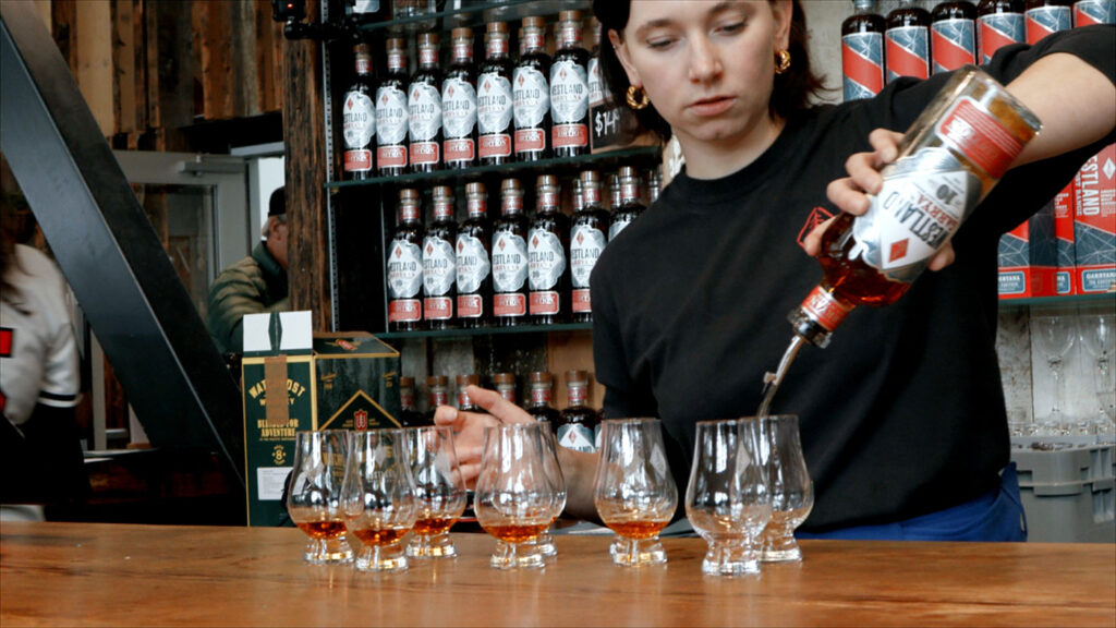 A bartender pours American single malt whiskey