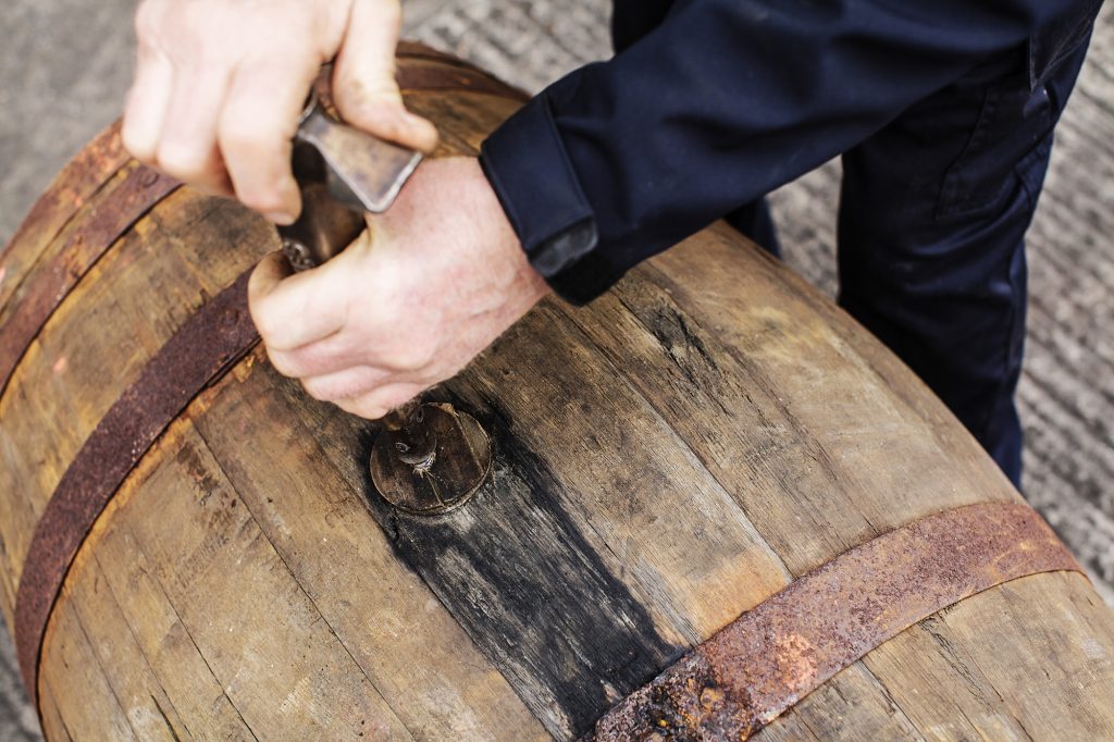 Hand on a whisky barrel