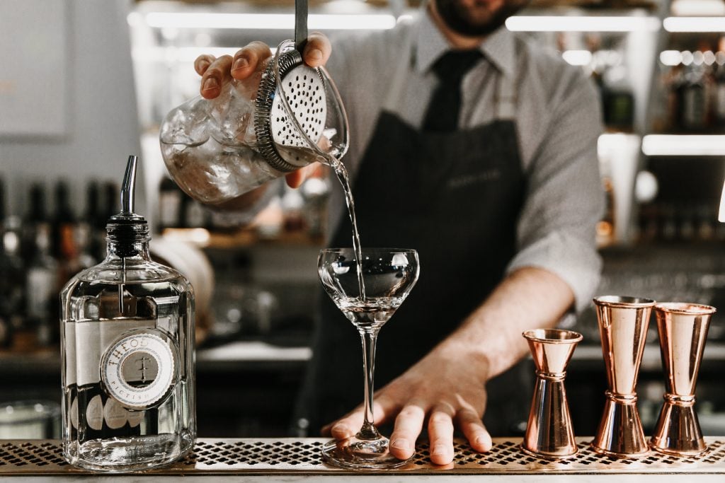 Barman pouring a drink