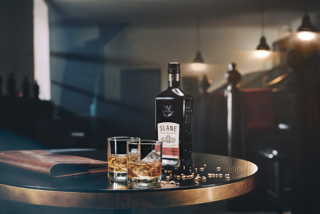 Slane Irish Whiskey in a dimly-lit bar