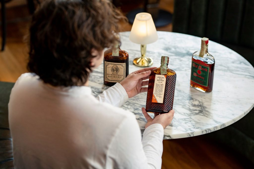Joe Wilson examining a Harry E. Wilken Prohibition-era bottling(1)