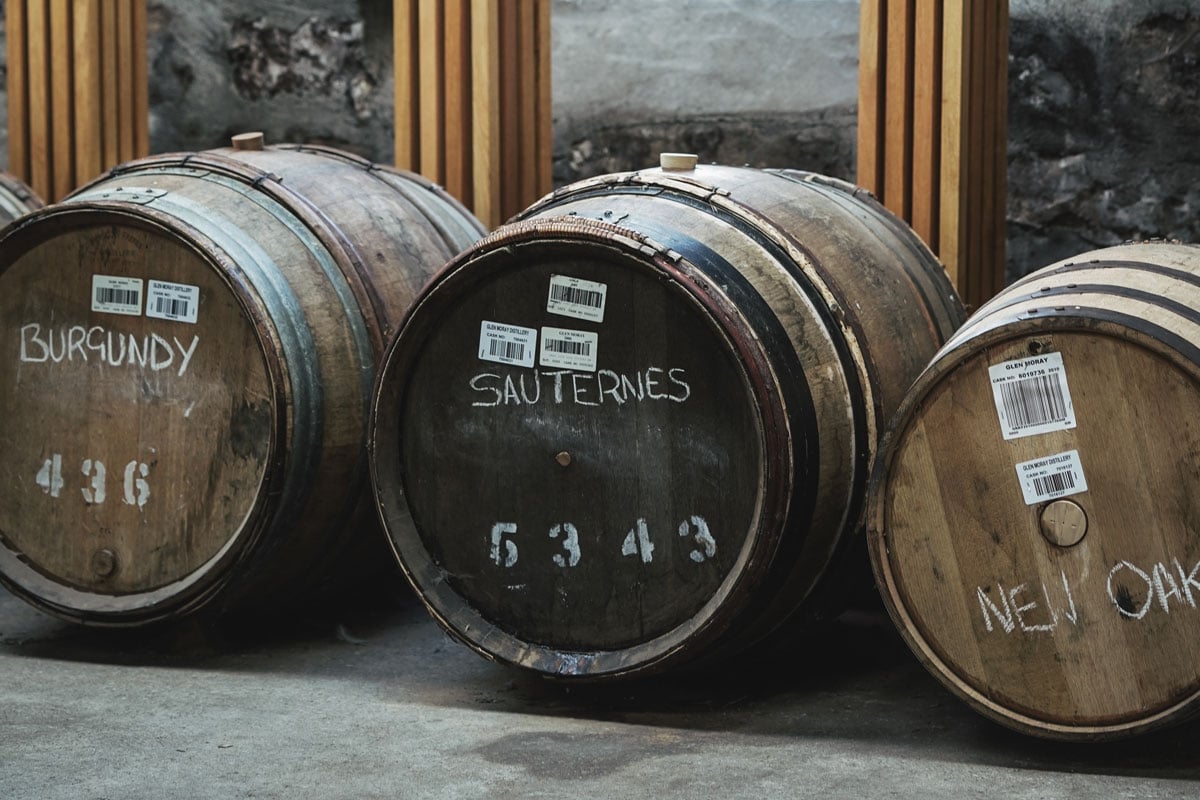 Three whisky casks marked Burgundy, Sauternes and New Oak in chalk