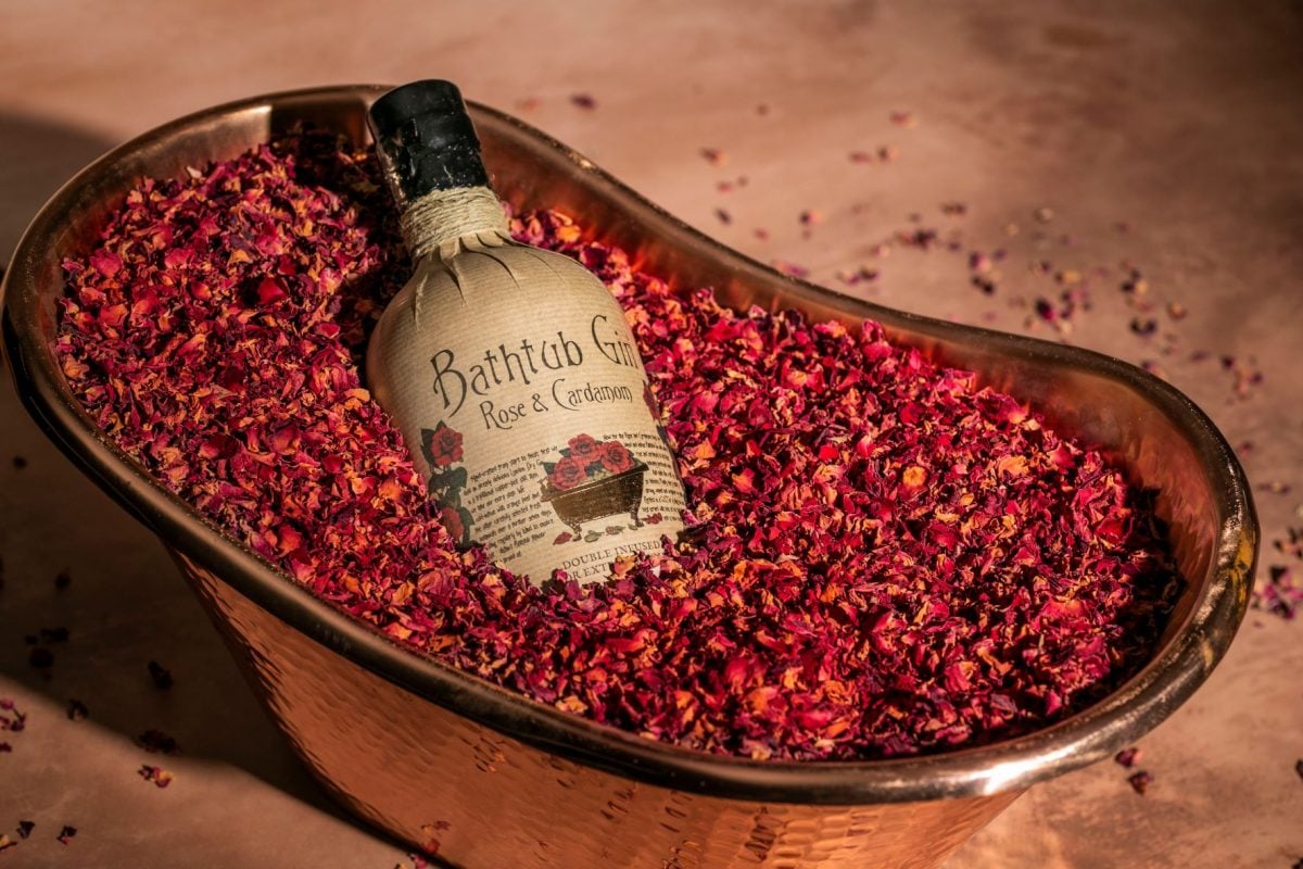 Gin in a bathtub of dried pink petals