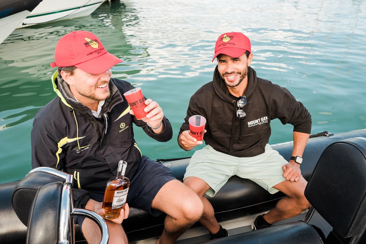 Two people drinking Mount Gay rum on a boat