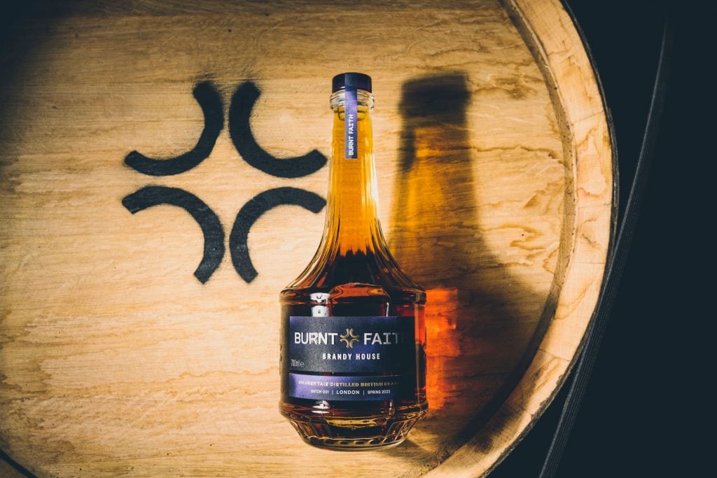 Burnt Faith brandy bottle on a barrel