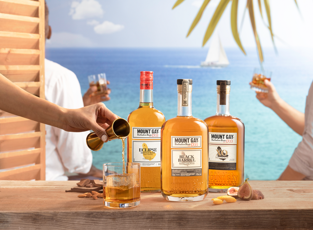 Bottles of Mount Gay rum on a bar by the beach