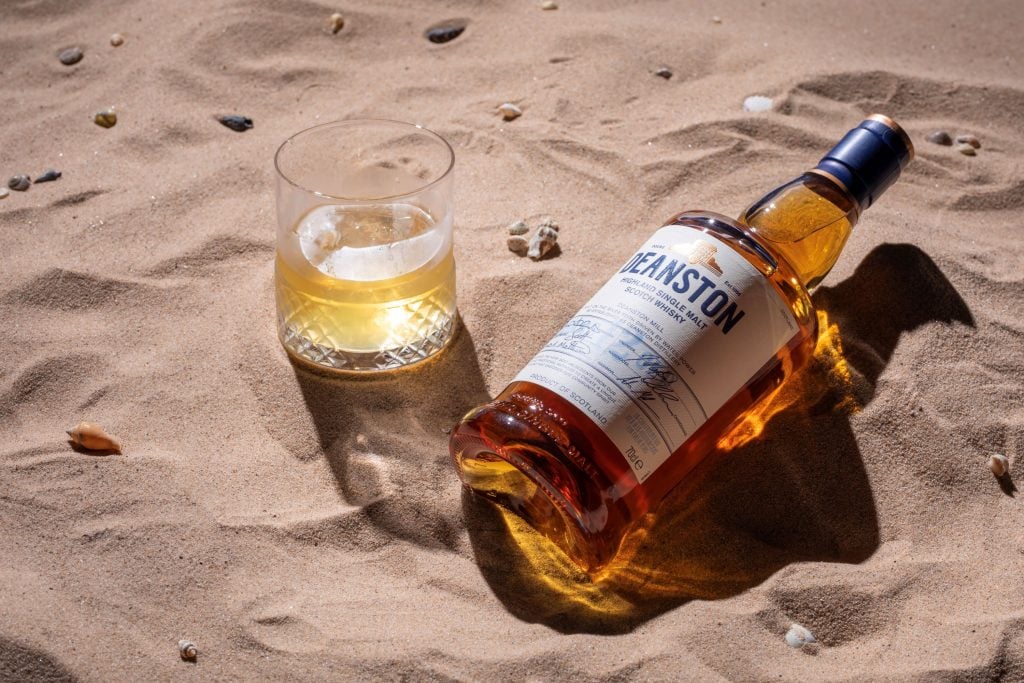 Deanston whisky on the rocks on the beach