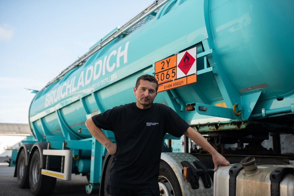 A truck from Bruichladdich usd for its Aqua Project, with a distillery worker in front