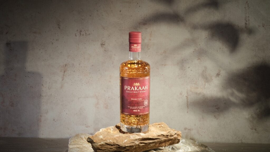 A bottle and glass of Prakaan Double Cask Thai Single Malt Whisky