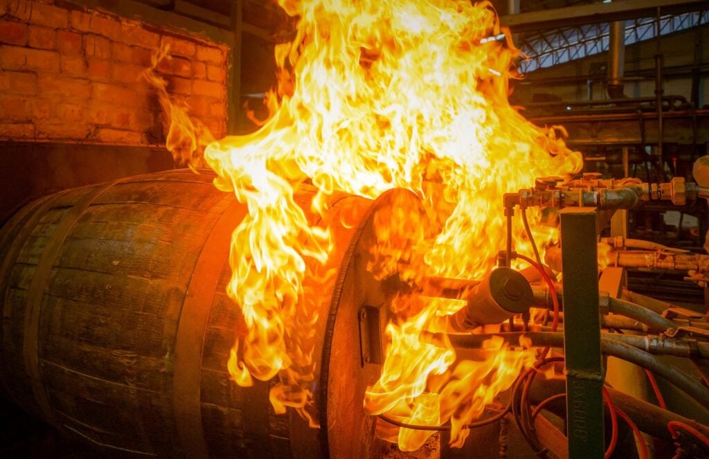 An oak barrel being charred