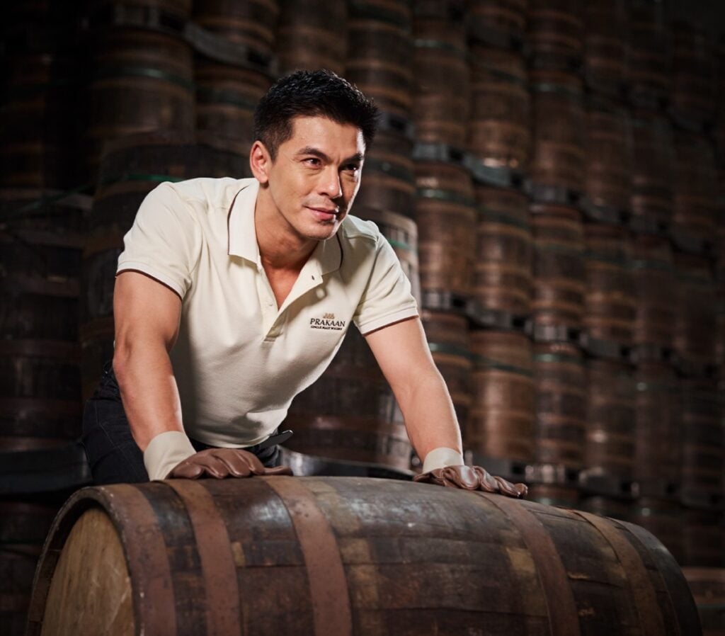 Inisde the Prakaan Whisky Warehouse, a distillery worker moves a cask of whisky