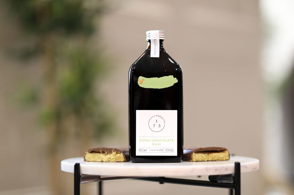 Project #173 Dubai Chocolate Rum on a table with Dubai chocolate