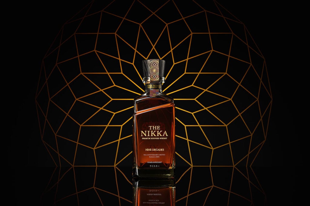 Nikka Nine Decades bottle with geometric background