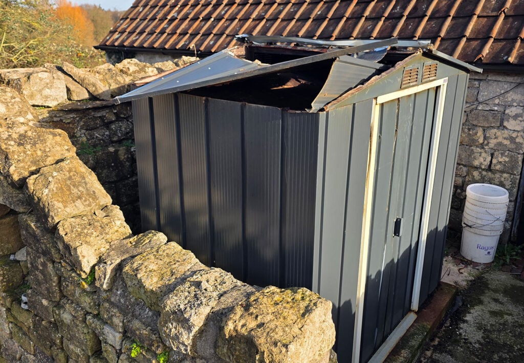 The smokehouse at Retribution Distilling showing storm damage