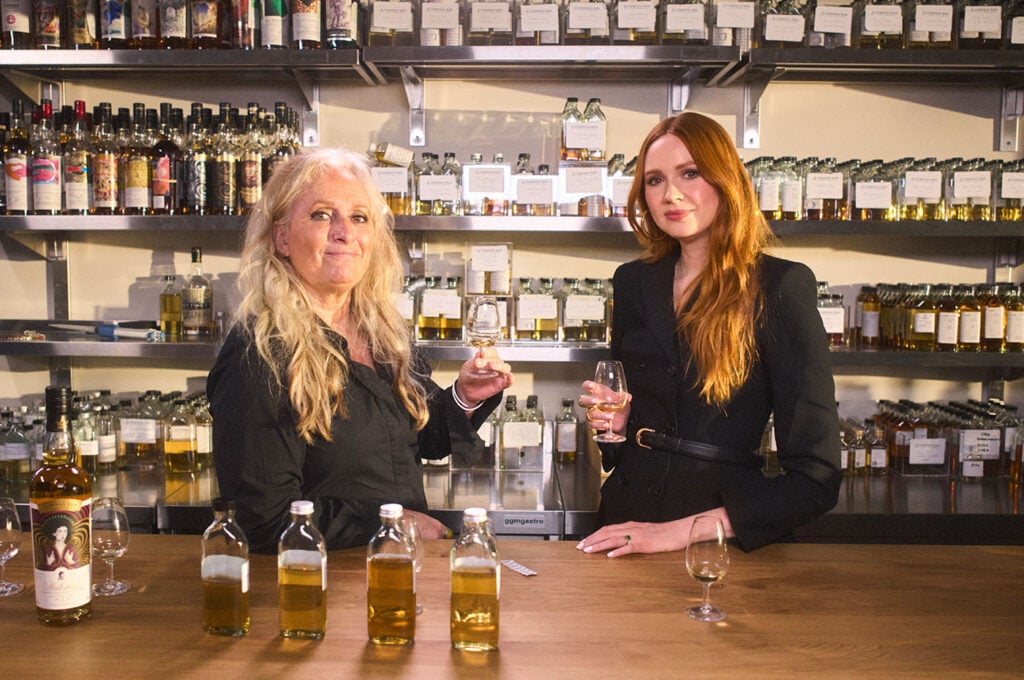 Compass Box whiskymaker Angela D’Orazio and Karen Gillan behind a bar with the 2026 editon of Hedonism
